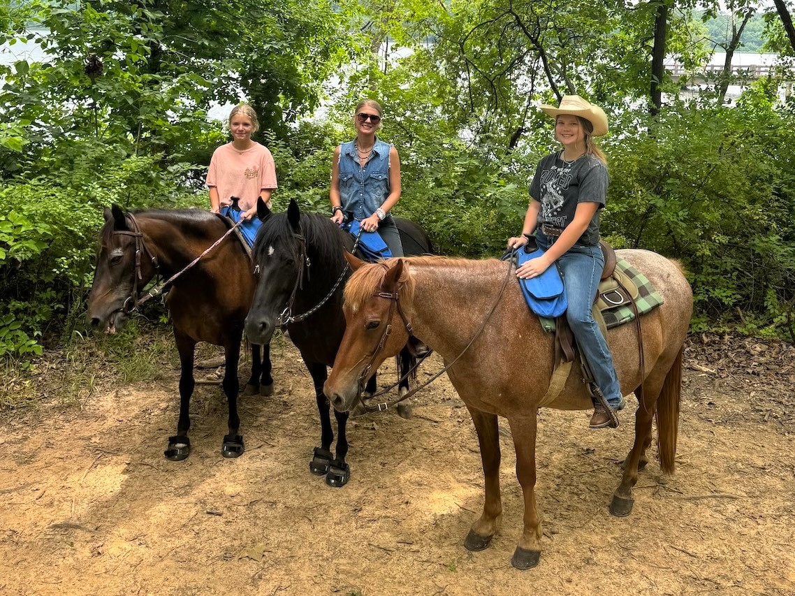 photo of Alicia Snow and her two daughters on horses