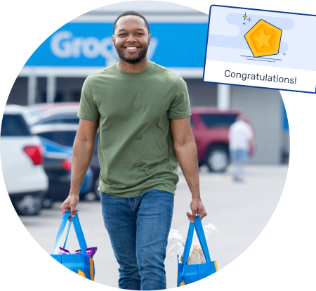photo of a smiling man carrying shopping bags outside a store